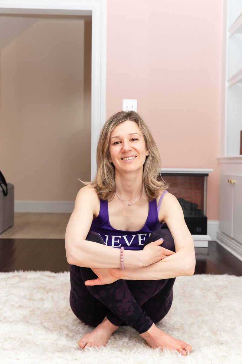 Dasha seated in yoga clothes