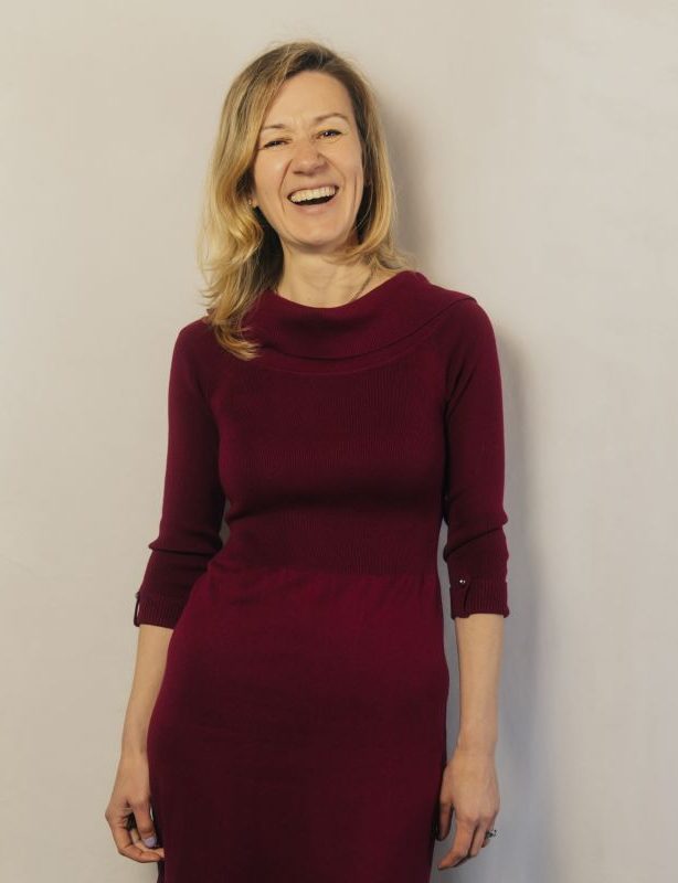 Dasha Tcherniakovskaia, laughing, in a burgundy dress